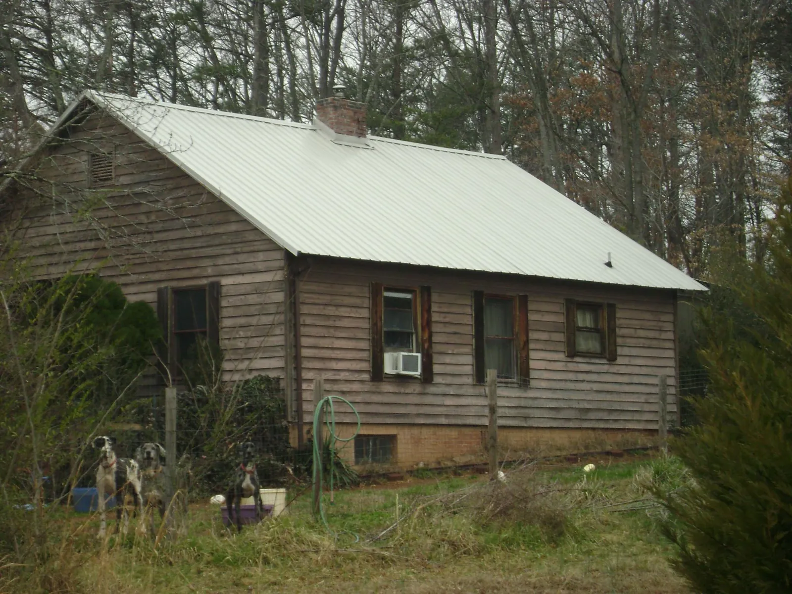 White metal roof on an old wood sided farmhouse, from a Metal Roof Installation job in Charlton